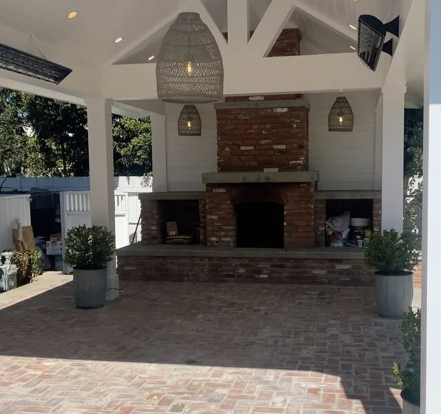 Outdoor fireplace with lantern sconces